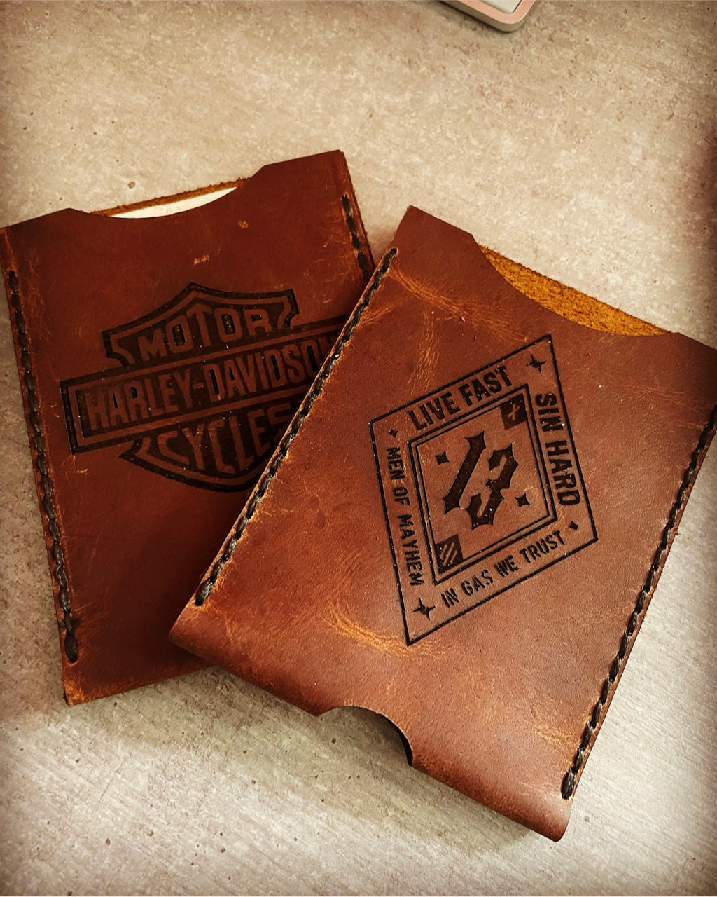 Zwei personalisierte Fahrzeugscheinhüllen aus Leder mit Motorrad-Motiven