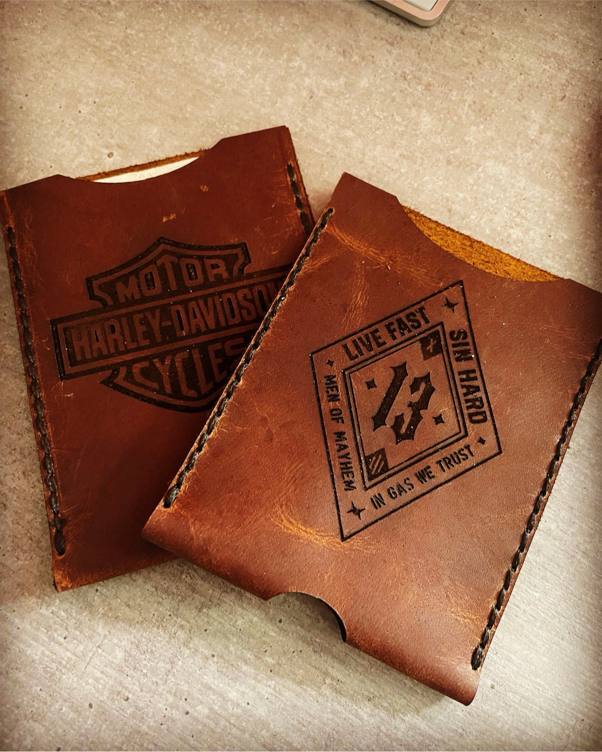 Zwei personalisierte Fahrzeugscheinhüllen aus Leder mit Motorrad-Motiven